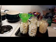 jars filled with marshmallows sitting on top of a stove