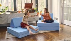 Two girls playing ice cream cone on a Bellbottom Nugget® Fun Couch, Nugget Couch, Toddler Play Area, The Nugget, Play Couch, Triangle Pillow, Activity Room, Room Seating, Toddler Play