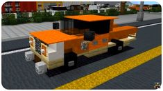 an orange and white truck driving down a street