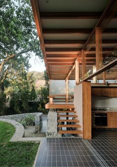 an outdoor kitchen with stairs leading up to it