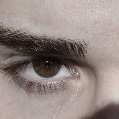 a close up of a person's brown eyes