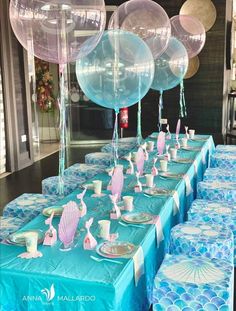 the table is set up with balloons and plates for an ocean themed birthday party or baby shower