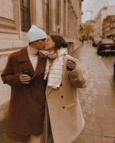 a man and woman kissing on the street