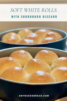 two pans filled with soft white rolls on top of a table