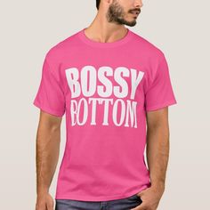 a man wearing a pink bossy bottom t - shirt with white letters on it