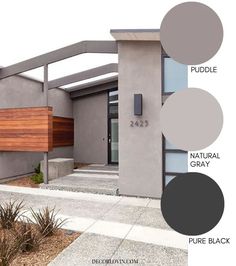 the exterior of a modern home with wood and gray paint samples on it's walls