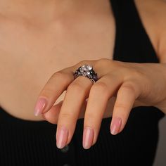 A cool black bat ring boasts a central, dazzling round gemstone, with bat images sculpted on both sides, infusing a touch of the macabre and the enchanting. Surrounding the main stone are sparkling purple and white stones, creating a striking and elegant contrast. Crafted from polished silver metal, the two tone fashion black ring features intricately carved black bat wing decorations, thereby enhancing its mystical charm. Inside, a spider's web-like hollowed-out lining lends an air of whimsy. It's a perfect fusion of sophistication, mystery, and allure, making it a standout accessory for any occasion.Carat Weight: 3.5 ctStone Size: 8 mmStone Type: Jeulia® StoneNumber of Stones: 1 Stone Color: Diamond WhiteStone Shape: RoundCarat Weight: 2.254 ctStone Size: 1.5,1,5*7 mmStone Type: Jeulia® Bat Images, Bat Ring, White Stones, Bat Wing, Black Ring, Black Bat, Fashion Black, Ring Sterling Silver, Bat Wings