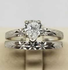 "We do not check prongs for wear or stones for looseness. All items are sold as is-noting that we are a resale shop so everything here had a previous owner! We will include flaws in the description when noted. This is one of the reasons our items are more affordable than new at a jewelry store. Vintage 14K White Gold Ring Set with a .60 Carat Pear Shaped Diamond, Size 7. There is 3 small diamonds on the engagement ring and 1 small diamond on each side of the pear shaped diamond. Neither band is Gia Certified Teardrop Ring For Anniversary, Gia Certified Teardrop Diamond Ring For Anniversary, Classic 14k Heart Cut Diamond Ring, Classic Teardrop Diamond Cut Ring, Heirloom Teardrop Diamond Ring For Anniversary, Classic Teardrop Gia Certified Diamond Ring, Platinum Rings Stamped 14k For Anniversary, Platinum Teardrop Jewelry For Anniversary, Teardrop Platinum Jewelry For Anniversary