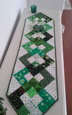 a green and white table runner on top of a counter