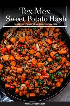 a skillet filled with sweet potato hashs and ground beef, on top of a table