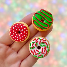 two miniature donuts with sprinkles on them are in someone's hand