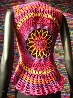 a crocheted top is displayed on a mannequin