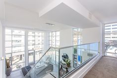 an empty room with glass railings and white walls