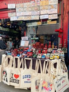 bags are on display in front of a shop with signs and magnets attached to it