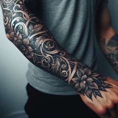 a man's arm covered in tattoos and flowers