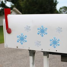 a white mailbox with blue snowflakes on it