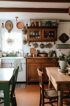 a kitchen filled with lots of wooden furniture and pots on top of the stovetop