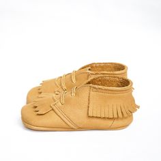 Free US shipping over $100 Crafted in America in our historic factory in Central Pennsylvania. The Acorn Tan Fringed Boot is made of soft suede with a matching flexible suede sole. All shoes will ship within 1-2 business days. Please carefully check our size guide and measure your child's foot before you order. Fall Leather Sole Closed Toe Moccasins, Fall Brown Textured Sole Moccasins, Fall Brown Moccasins With Textured Sole, Brown Moccasins With Textured Sole For Fall, Brown Suede Moccasins For Fall, Fall Suede Moccasins With Rubber Sole, Suede Moccasins With Rubber Sole And Round Toe, Brown Moccasins With Rubber Sole For Fall, Brown Closed Toe Soft Sole Moccasins