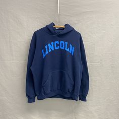 Large / 1990s Lincoln College Russell Navy/Aqua Crest University Boxy Hoodie Sweatshirt Pit to Pit: 21.5in Top Collar to Bottom: 26in Sleeve Length: 33in Oversized Vintage Hoodie For College, Blue Retro Winter Hoodie, Vintage Blue Hoodie For Streetwear, Vintage College Hoodie Tops, 90s Oversized Crew Neck Hoodie, 90s Style Oversized Crew Neck Hoodie, 90s Oversized Hoodie With Crew Neck, Blue Retro Long Sleeve Hoodie, Blue Long Sleeve Retro Hoodie