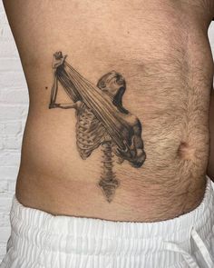 a man with a skeleton tattoo on his stomach holding a scapula in the shape of a human body