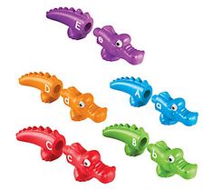 an assortment of different colored plastic alligators with the letters e and f in them