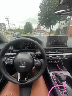 the interior of a car with steering wheel, dashboard and electronic display showing on screen