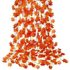 an arrangement of orange leaves hanging from the ceiling