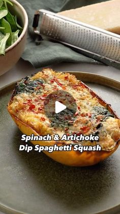 spinach and artichoke dip spaghetti squash on a plate next to a salad