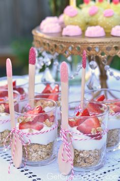 baby shower desserts with strawberries and cupcakes in the middle on a table