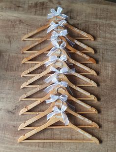 a bunch of wooden clothes hangers with ribbons