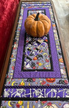 a table runner with a pumpkin on it