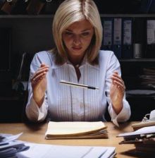 a woman sitting at a desk in front of books