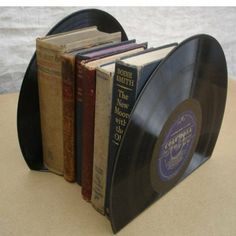 an old record book holder is holding several books