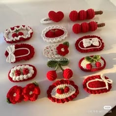 there are many crocheted items on the table and one has strawberries in it