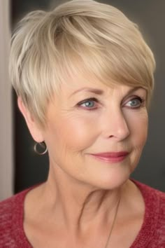 The short pixie with side bangs in blonde is a modern choice for women over 70. This short hairstyle adds a touch to your overall look. Click here to check out more flattering hairstyles for women over 70. Side Swept Pixie Haircut, 1970s Pixie Haircut, Short Bob Hairstyles With Side Bangs, Middle Parting Hairstyles, Short Hairstyle Women 60s Style, 1960 Pixie Haircut, Short Coloured Hair, Short Hair Style For Women Over 60 With Glasses, Fine Hair Pixie Cut