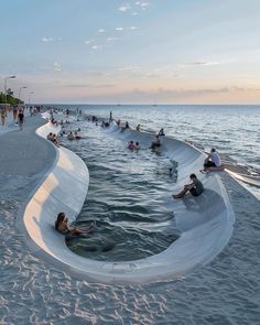 people are swimming in the water at the beach