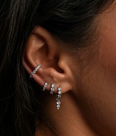 Meet the Skye Hoop, our most sparkling earring yet. Crafted from sterling silver and adorned with cubic zirconia, these hoops are designed to let as much light in as possible, making them truly sparkle from every angle. Available in three versatile sizes—8mm, 6.5mm, and 5.5mm—these hoops are perfect for stacking or wearing in cartilage piercings, allowing you to create a personalised ear stack that shines. Whether worn solo or layered with other pieces, the Skye Hoop is destined to become your g Lower Ear Piercing, Stacked Earrings Silver, Silver Jewelry Earring Stack, Bridal Earring Stack, Elegant Piercings Ears, Ear Stack Silver, Earring Stacks Silver, Elegant Ear Piercings, Earrings Combinations