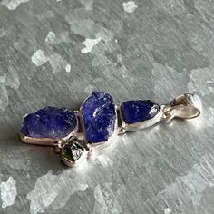 "Tanzanite Rough & Genuine Moldavite Pendant in 925 Sterling Silver and 1 3/4\" in Height (including the bail). ✓You'll receive your new pendant in the signature gift box ✓Tanzanite Rough & Genuine Moldavite ✓Because of the natural crystal structure, natural gemstones could have some small visible scars and crackles. ✓ Solid 925 Sterling Silver (925 parts per 1000) ✓ Silver Hallmark on every item ✓ Handcrafted ✓ Every natural stone is different and exclusive in pattern and shape, and with its un Silver Tanzanite Jewelry Gift, Silver Tanzanite Pendant Jewelry, Unique Tanzanite Jewelry Gift, Unique Tanzanite Jewelry For Gifts, Handmade Tanzanite Jewelry Gift, Handmade Tanzanite Jewelry For Gifts, Tanzanite Meaning, Moldavite Pendant, Crystal Structure