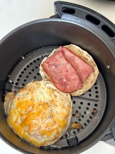 an omelet and some meat in a frying pan