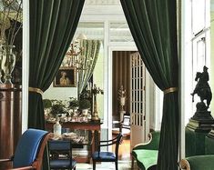 a living room filled with furniture and green curtains