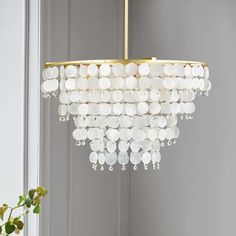 a white chandelier hanging from a ceiling