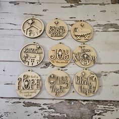 twelve wooden christmas ornament hanging on a white wood background with the names of different countries