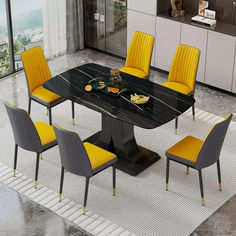 a dining table with yellow chairs around it