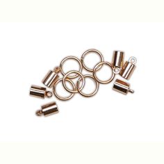 brass plated jump rings with loops and hooks on a white background for use in jewelry making