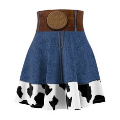 a skirt with a cow print on the side and a brown leather button at the waist