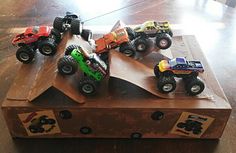 a wooden box with monster trucks on it