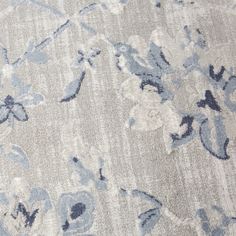 an area rug with blue and white flowers on it