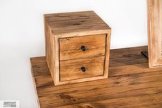 two wooden drawers sitting on top of a wooden table