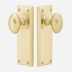 two brass door handles with knobs on each side