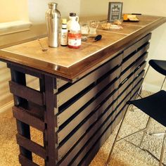 a bar made out of pallets with bottles on top